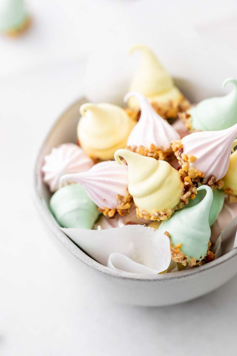 An easy recipe for making easter meringue kisses, dipped in chocolate and coated with nuts. A dairy and gluten free cookie recipe
