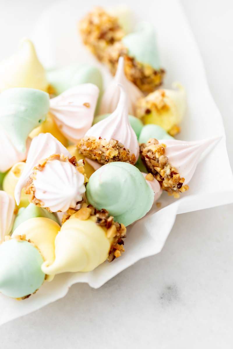 An easy recipe for making easter meringue kisses, dipped in chocolate and coated with nuts. A dairy and gluten free cookie recipe