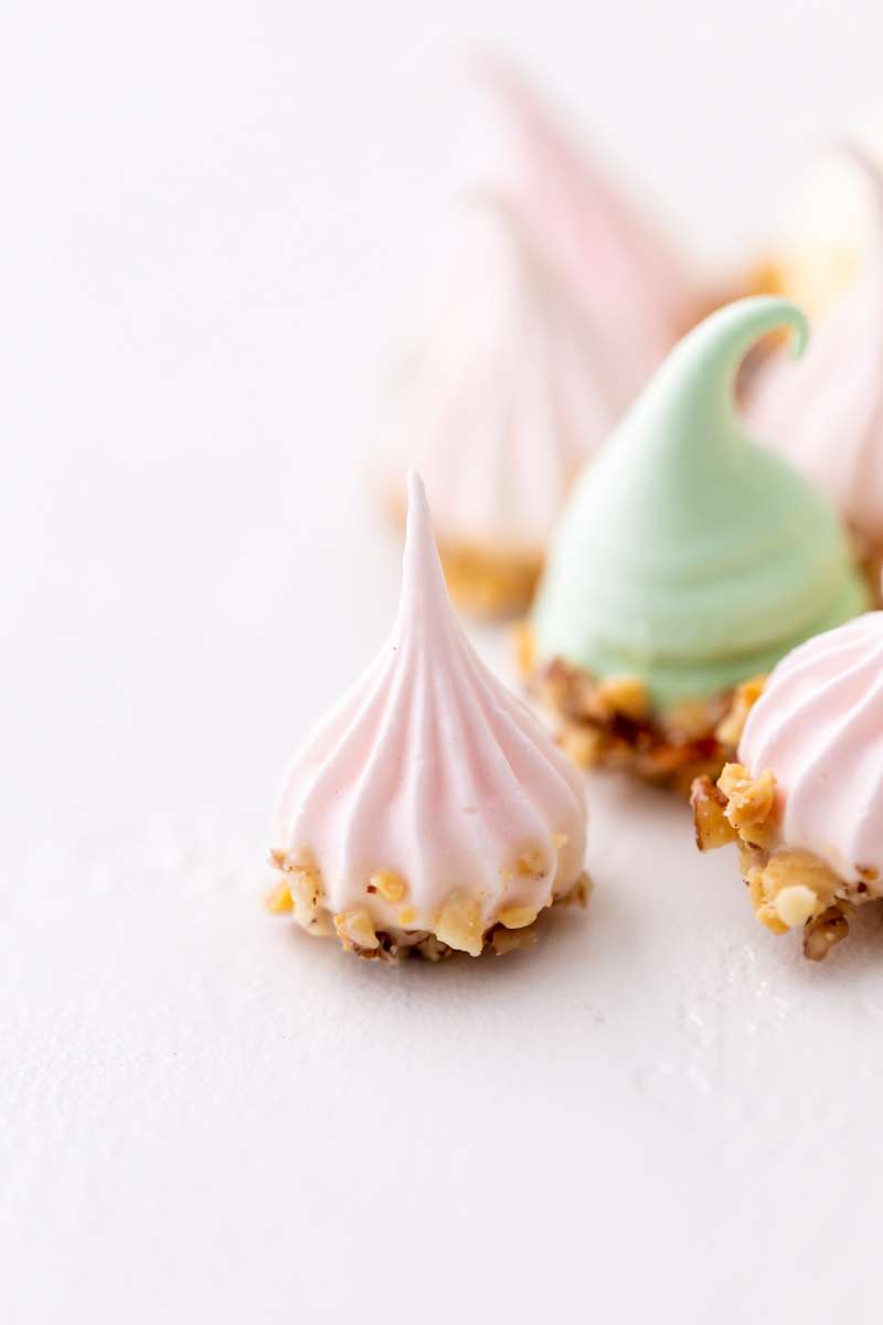 An easy recipe for making easter meringue kisses, dipped in chocolate and coated with nuts. A dairy and gluten free cookie recipe