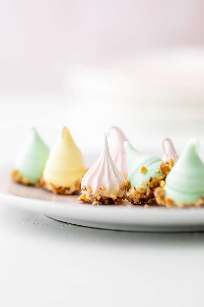 An easy recipe for making easter meringue kisses, dipped in chocolate and coated with nuts. A dairy and gluten free cookie recipe