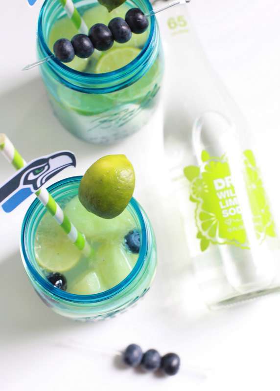 Super Bowl Sangria recipe with blueberries, melon, and lime slices in a glass