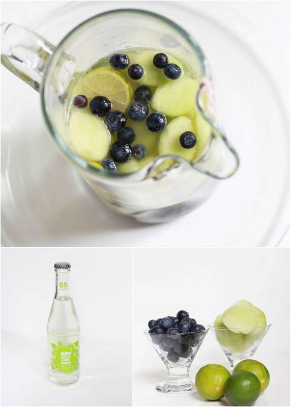 Super Bowl Sangria recipe with blueberries, melon, and lime slices in a glass