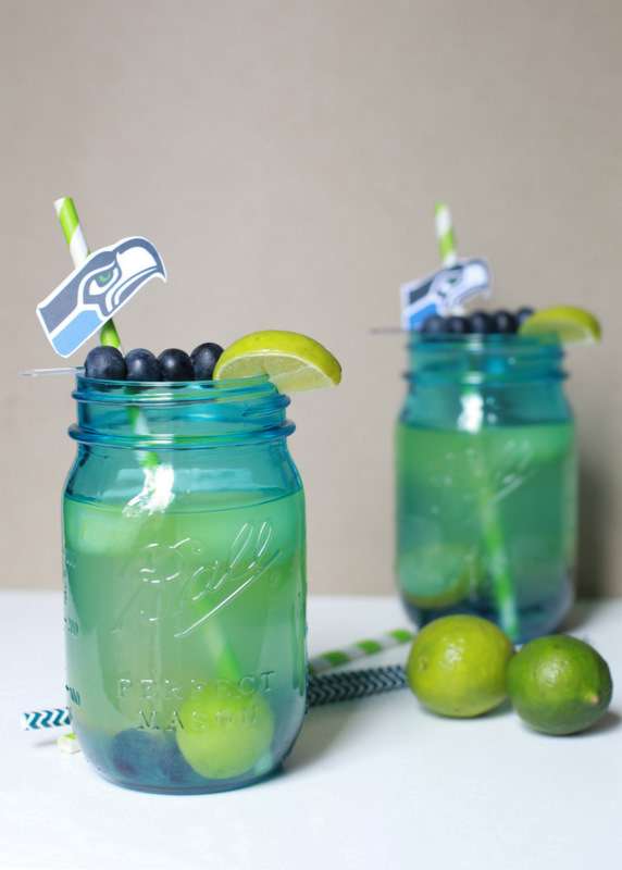 Super Bowl Sangria recipe with blueberries, melon, and lime slices in a glass