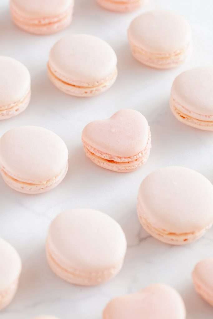 A photo of smooth elegant French macarons with clean feet, styled neatly by Posh Little Designs