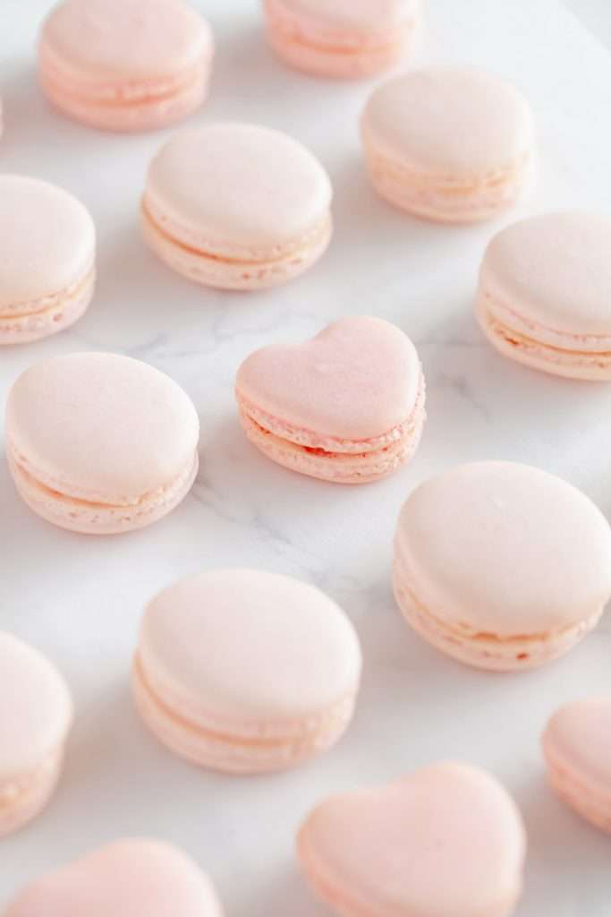 A photo of smooth elegant French macarons with clean feet, styled neatly by Posh Little Designs