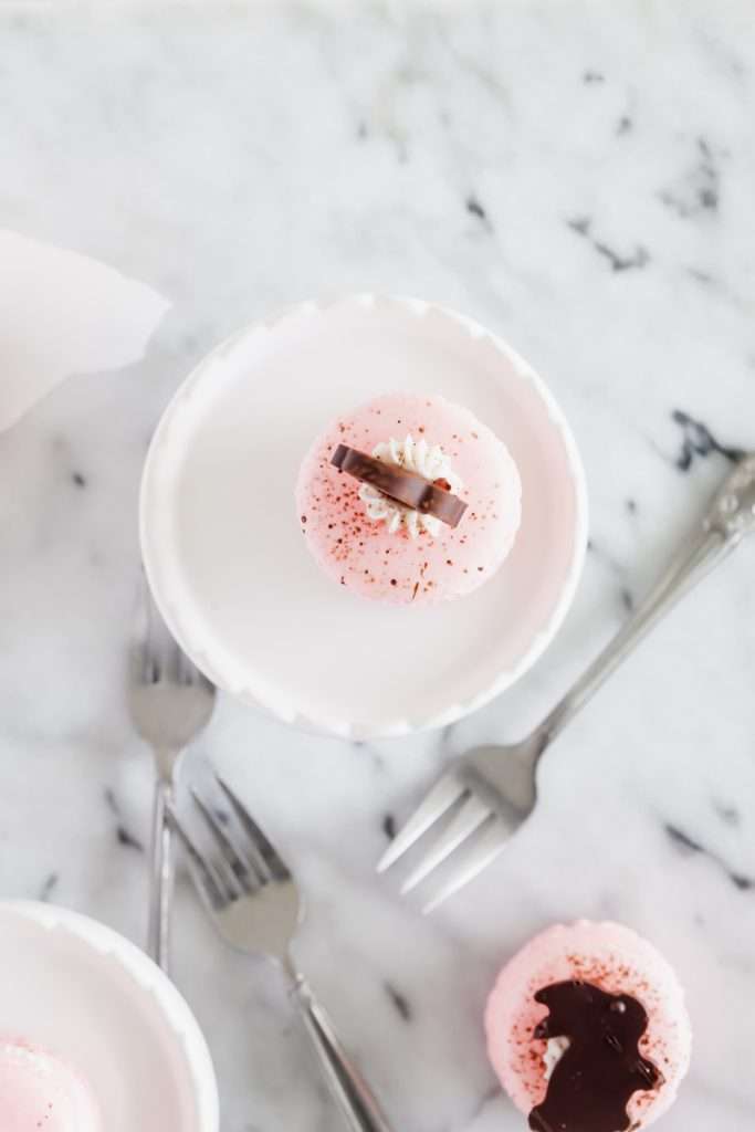 Chocolate bunny macarons stacks, 3 shells high, layered with speckled macaron shells, vanilla frosting and finished with cute chocolate bunnies. Perfect for your Easter Sunday brunch dessert menus.