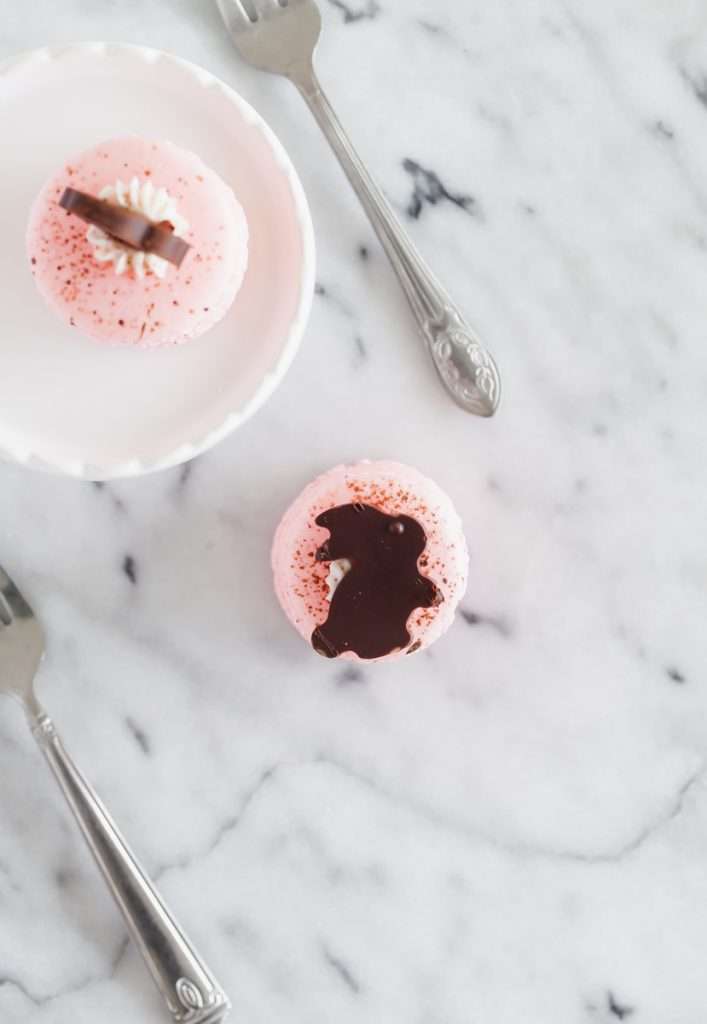 Chocolate bunny macarons stacks, 3 shells high, layered with speckled macaron shells, vanilla frosting and finished with cute chocolate bunnies. Perfect for your Easter Sunday brunch dessert menus.