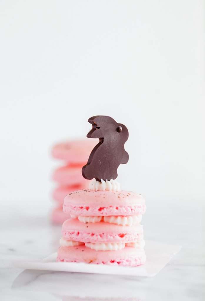 Chocolate bunny macarons stacks, 3 shells high, layered with speckled macaron shells, vanilla frosting and finished with cute chocolate bunnies. Perfect for your Easter Sunday brunch dessert menus.
