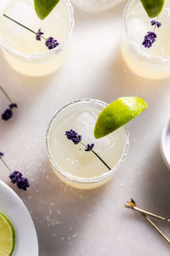 Easy homemade lavender margaritas recipe, complete with lavender simple syrup, fresh squeezed lime juice cointreau and tequila. Mix in advance and enjoy at your next summer gathering!