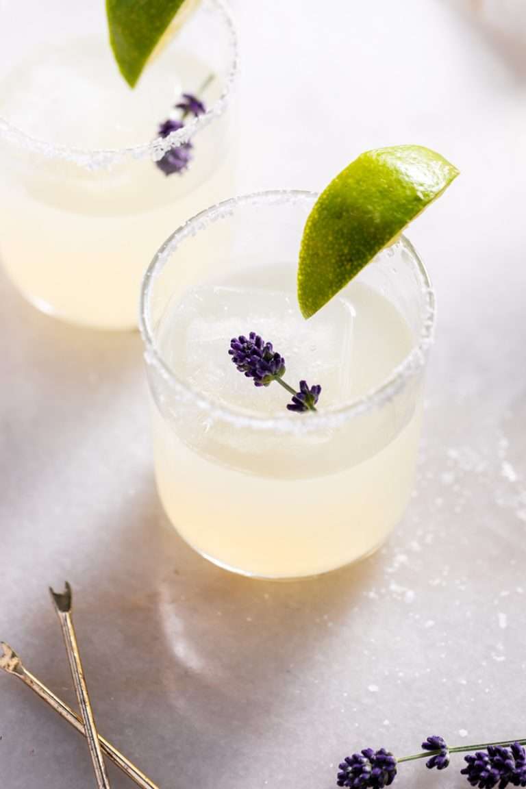 Easy homemade lavender margaritas recipe, complete with lavender simple syrup, fresh squeezed lime juice cointreau and tequila. Mix in advance and enjoy at your next summer gathering!