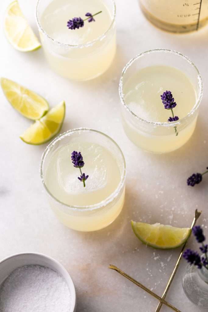 Easy homemade lavender margaritas recipe, complete with lavender simple syrup, fresh squeezed lime juice cointreau and tequila. Mix in advance and enjoy at your next summer gathering!