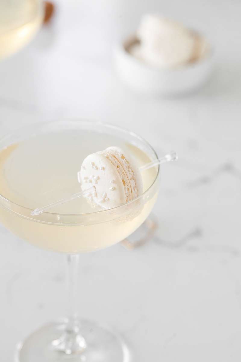 Sparkling Vanilla Macaron Cocktail recipe, made with just a few simple ingredients and a french macaron garnish.