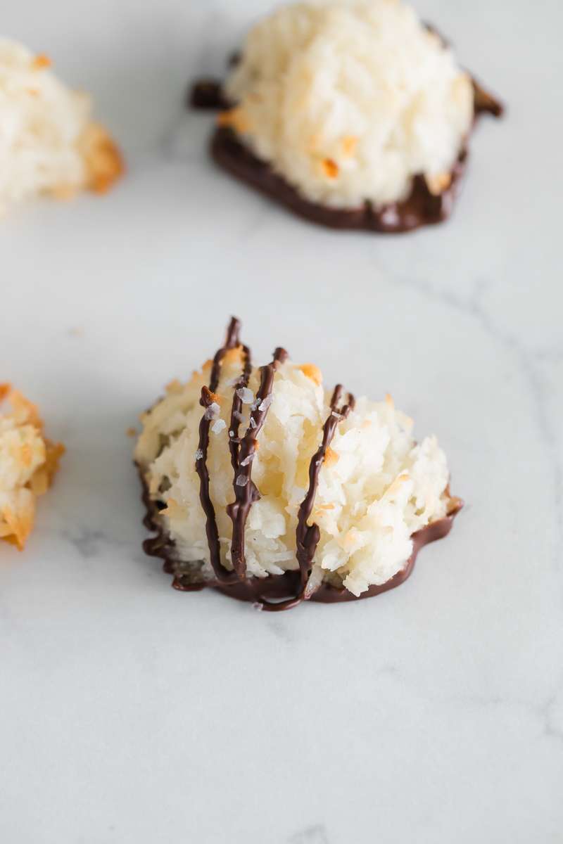 an easy recipe for coconut macaroons, gluten and dairy free with only 6 pantry ingredients needed. Dipped in dark chocolate