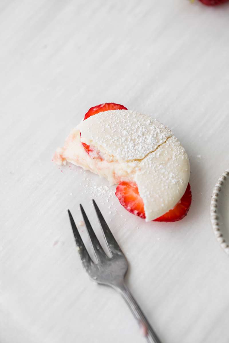 Strawberry shortcake macarons recipe, made with French macaron shells, fresh strawberries and vanilla whip frosting. Dairy and gluten free