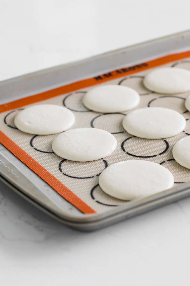 Strawberry shortcake macarons recipe, made with French macaron shells, fresh strawberries and vanilla whip frosting. Dairy and gluten free