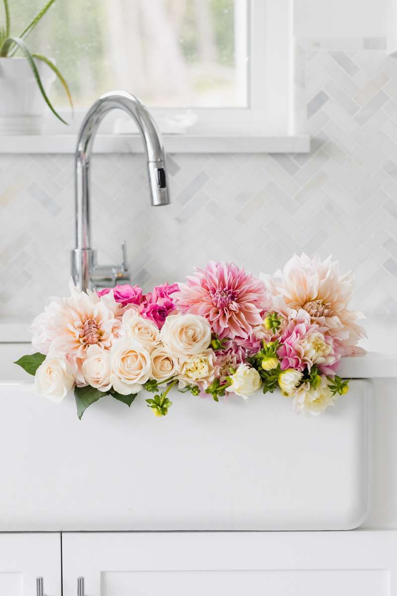 Fresh flowers in a white sink - dahlias roses