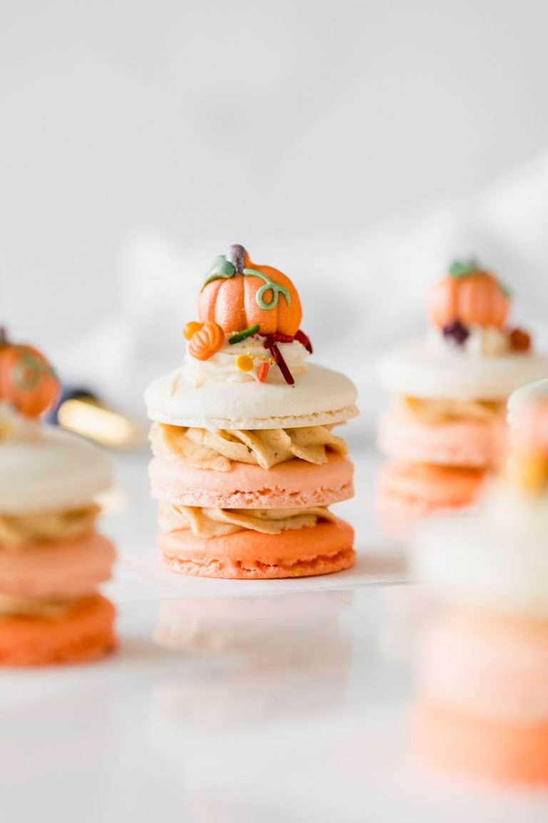 A recipe for pumpkin spice latte french macaron stacks topped with autumn decorations from Wilton. Dairy & gluten free