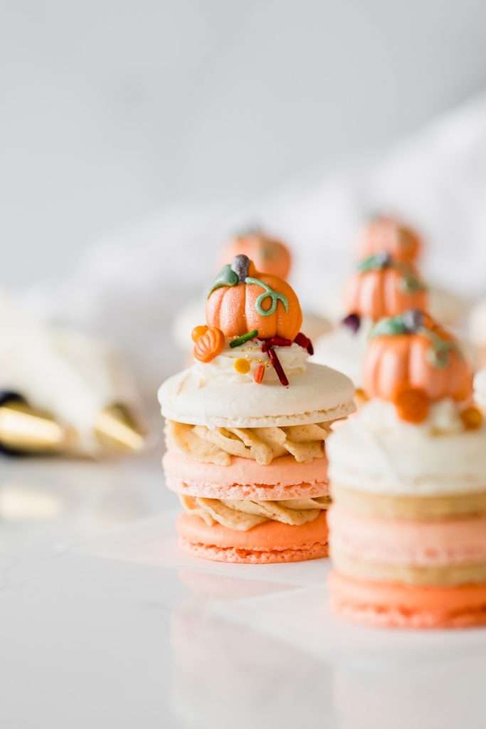 a new recipe for pumpkin spice latte french macaron stacks topped with autumn decorations from Wilton. Dairy & gluten free