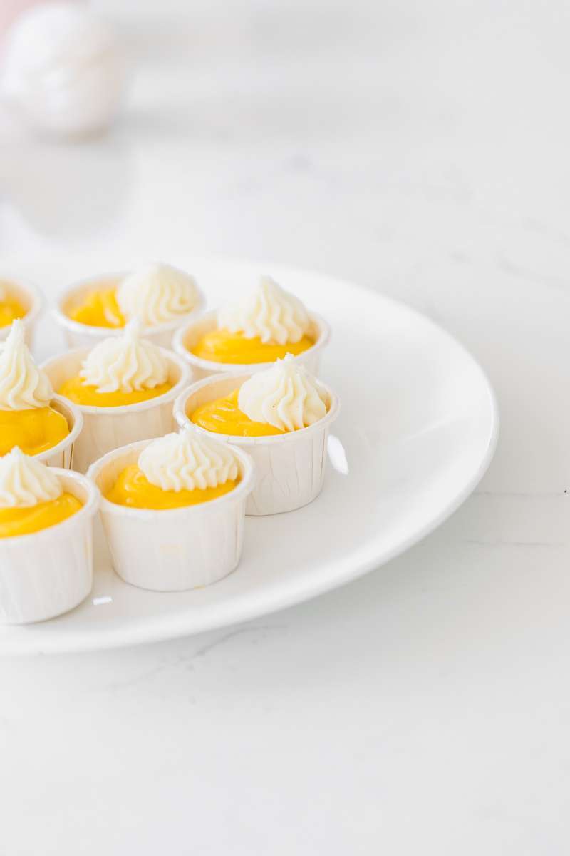 miniature mango curd cake cups with vanilla frosting