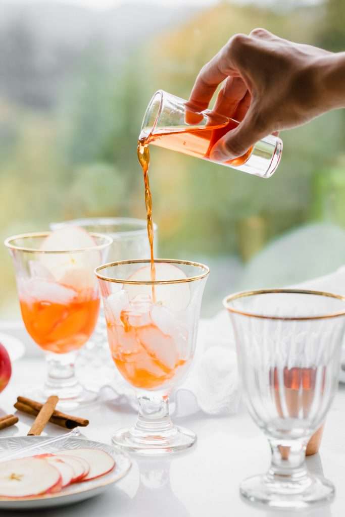 A mix of hard apple cider, Aperol and club soda garnished with cinnamon sticks and thinly sliced apple rounds, make up this light and refreshing twist on the classic Aperol Spritz. The perfect fall and autumn cocktail with warm spices. 