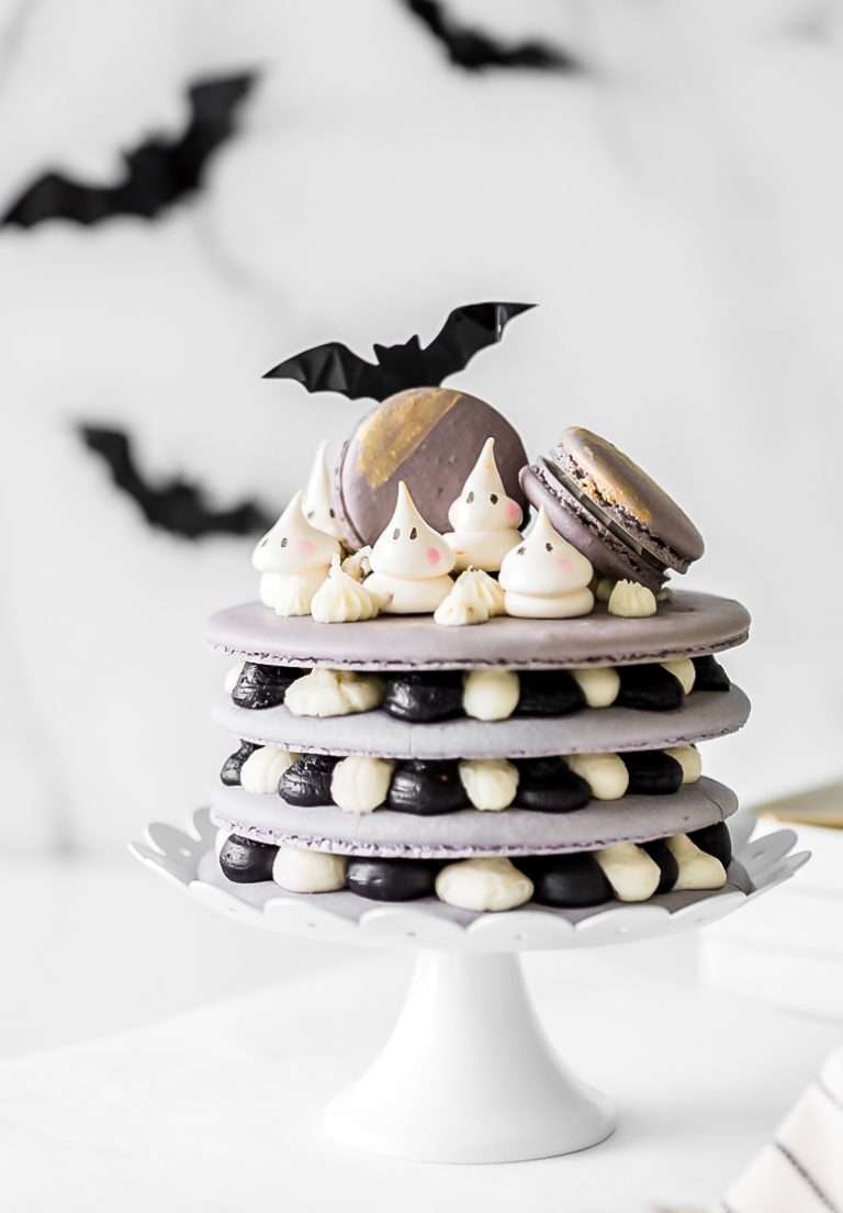 A Halloween themed french macaron cake recipe with ghost meringues and black cocoa frosting. Dairy & Gluten Free