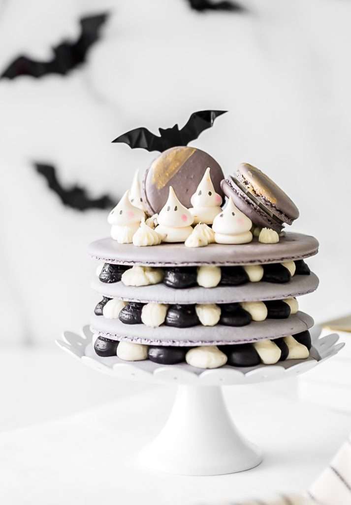 A Halloween themed french macaron cake recipe with ghost meringues and black cocoa frosting. Dairy & Gluten Free