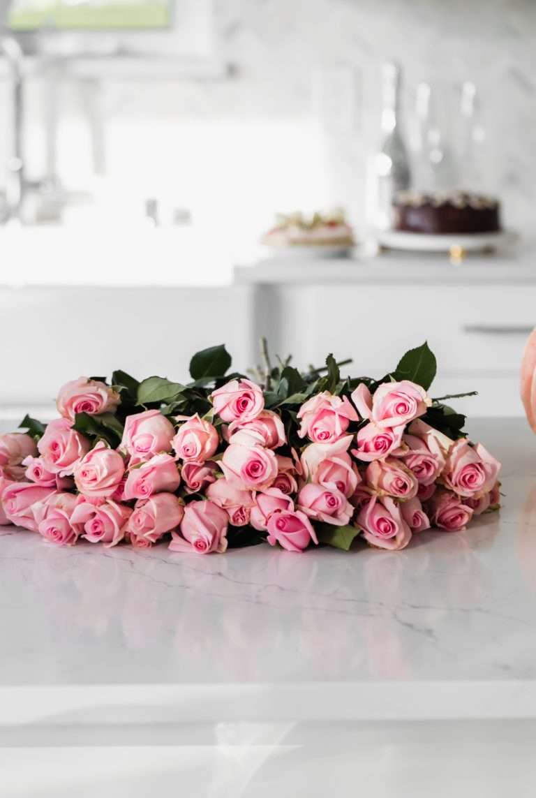 pink roses in white kitchen