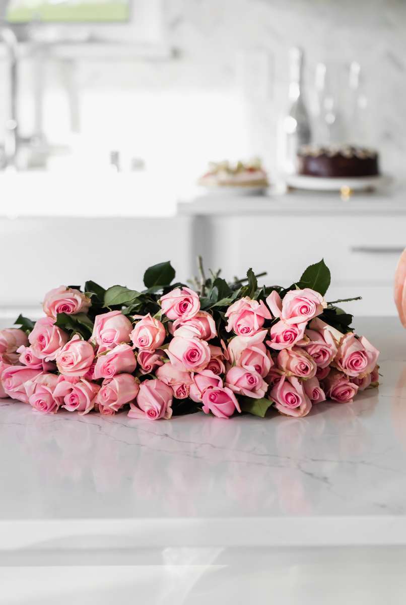 pink roses in a white kitchen
