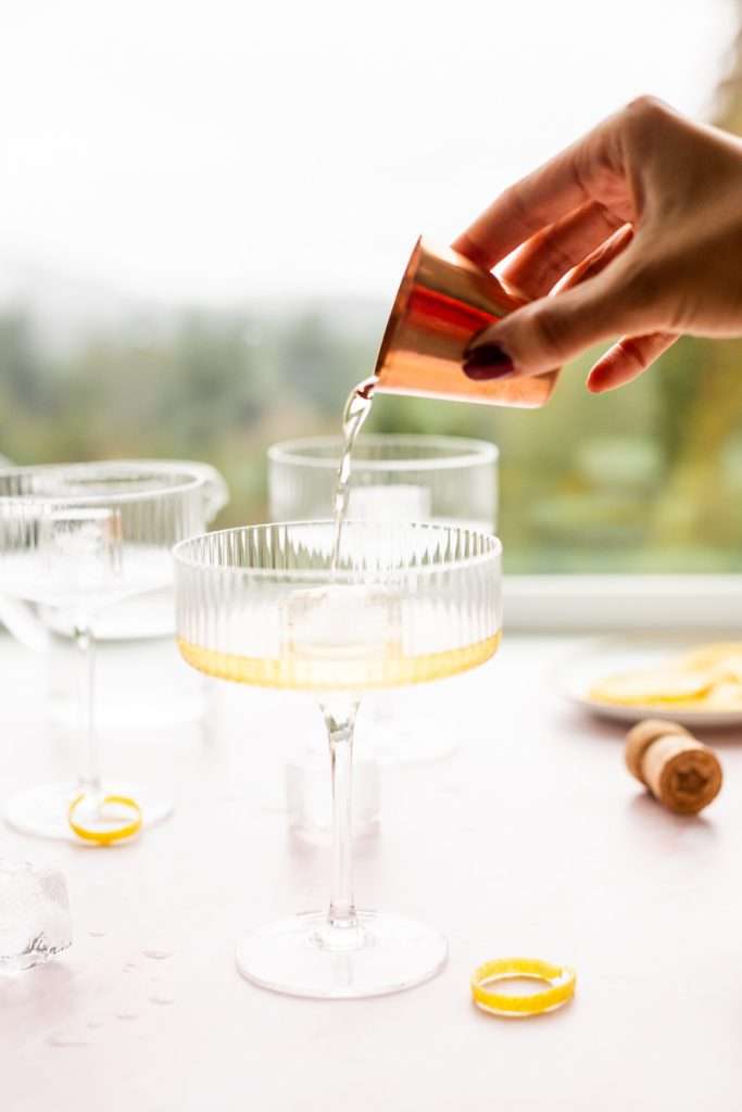 Sparkling Hummingbird cocktail made with St Germain elderflower liqueur, champagne, club soda and lemon, served over ice.