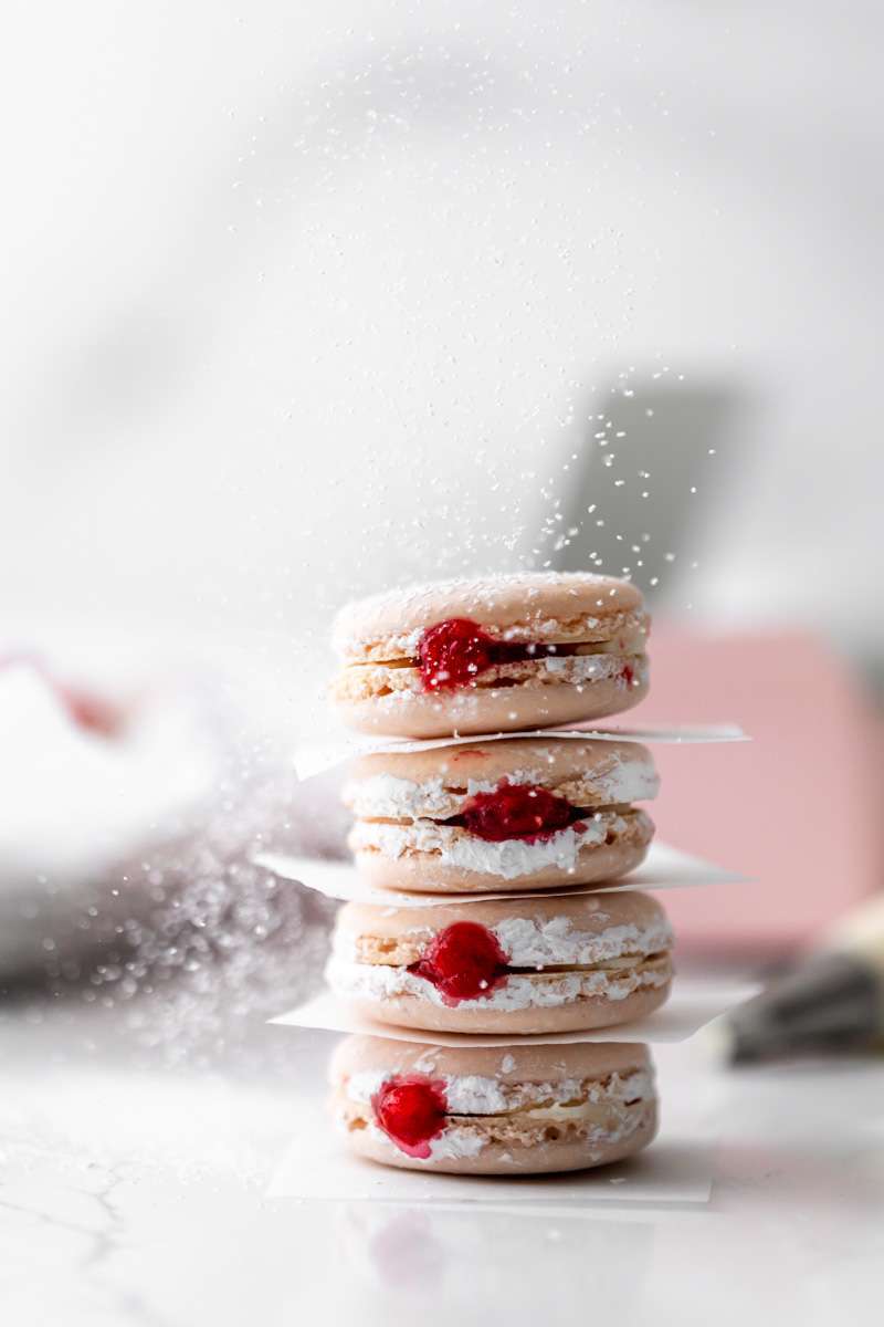 jelly donut flavored French macarons made with donut frosting, homemade raspberry jam and confectioner's sugar