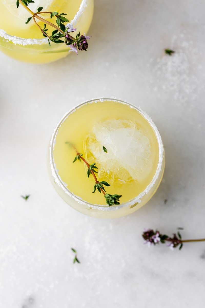 Thyme infused margaritas made with homemade thyme simple syrup, fresh lime, tequila and cointreau. The perfect herbal garden cocktail recipe for spring and summer entertaining.