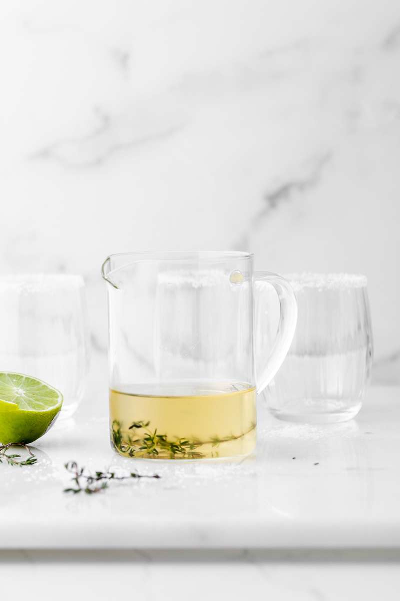 Thyme infused margaritas made with homemade thyme simple syrup, fresh lime, tequila and cointreau. The perfect herbal garden cocktail recipe for spring and summer entertaining.