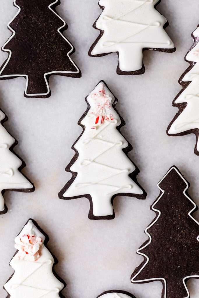 These peppermint black cocoa sugar cookies are rich, chocolatey and perfectly festive for the holidays. Made with rich black cocoa powder and a dash of peppermint they are ideal for Christmas cookies boxes and festive winter baking. Decorate with royal icing and crushed peppermint for a festive and delicious finish.