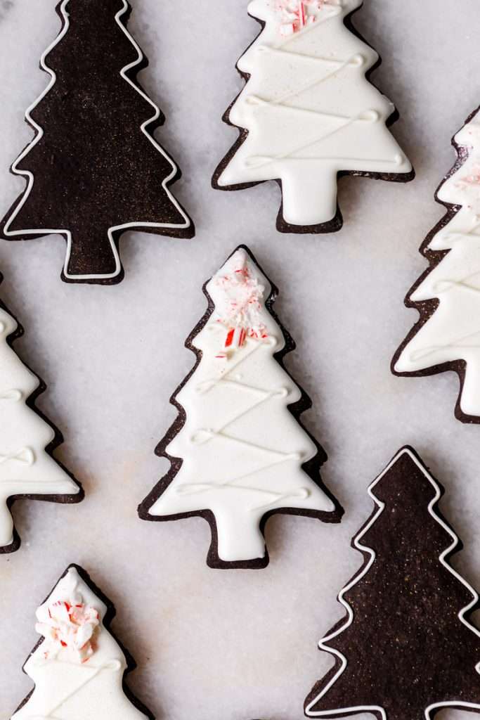 These peppermint black cocoa sugar cookies are rich, chocolatey and perfectly festive for the holidays. Made with rich black cocoa powder and a dash of peppermint they are ideal for Christmas cookies boxes and festive winter baking. Decorate with royal icing and crushed peppermint for a festive and delicious finish.