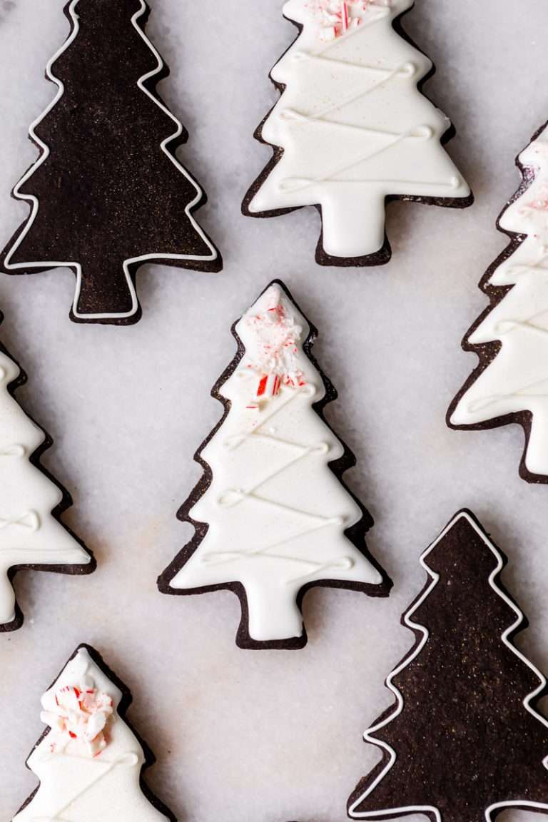 These peppermint black cocoa sugar cookies are rich, chocolatey and perfectly festive for the holidays. Made with rich black cocoa powder and a dash of peppermint they are ideal for Christmas cookies boxes and festive winter baking. Decorate with royal icing and crushed peppermint for a festive and delicious finish.
