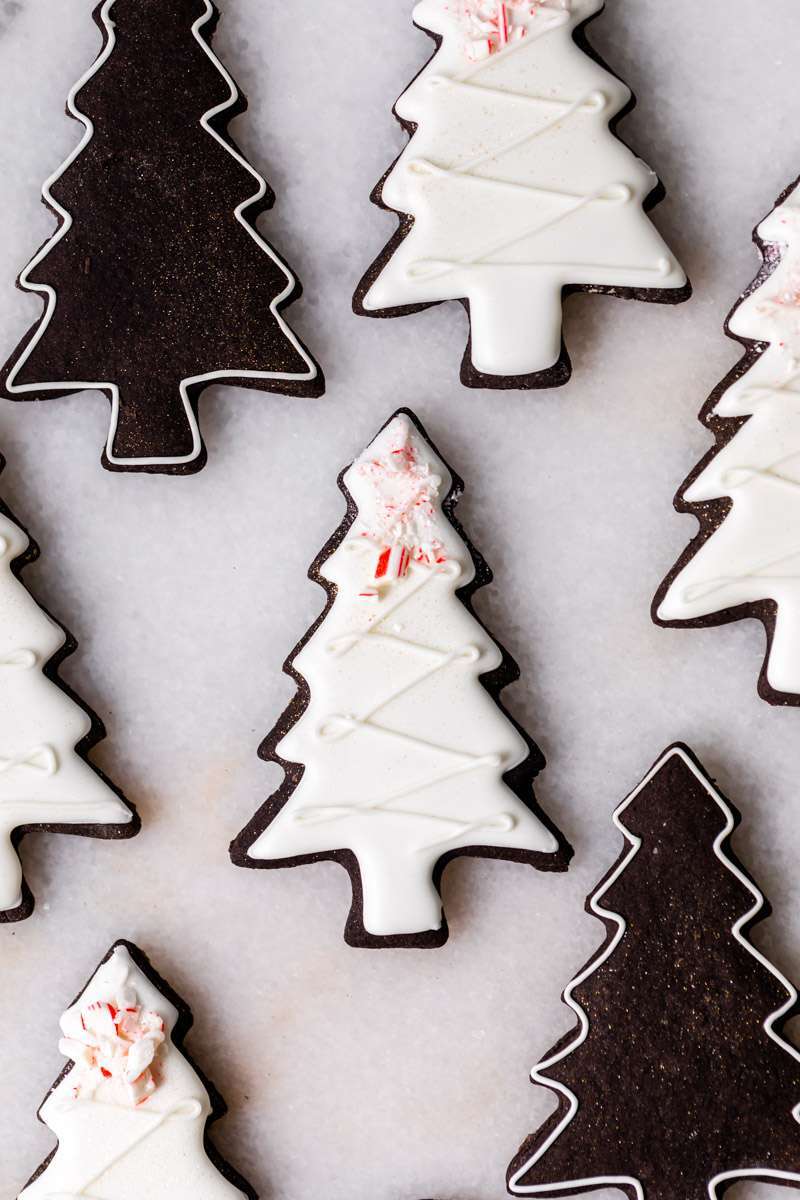 These peppermint black cocoa sugar cookies are rich, chocolatey and perfectly festive for the holidays. Made with rich black cocoa powder and a dash of peppermint they are ideal for Christmas cookies boxes and festive winter baking. Decorate with royal icing and crushed peppermint for a festive and delicious finish.