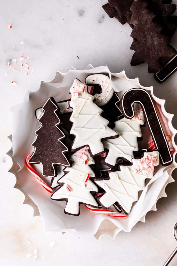 Easy and delicious black cocoa peppermint sugar cookies with royal icing. Follow the easy recipe to whip up a batch for Christmas and the holiday season. Dairy free