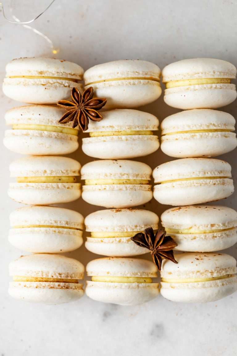Eggnog French macarons filled with eggnog infused frosting and dusted with nutmeg. A delicious dessert rendition of the classic holiday drink!