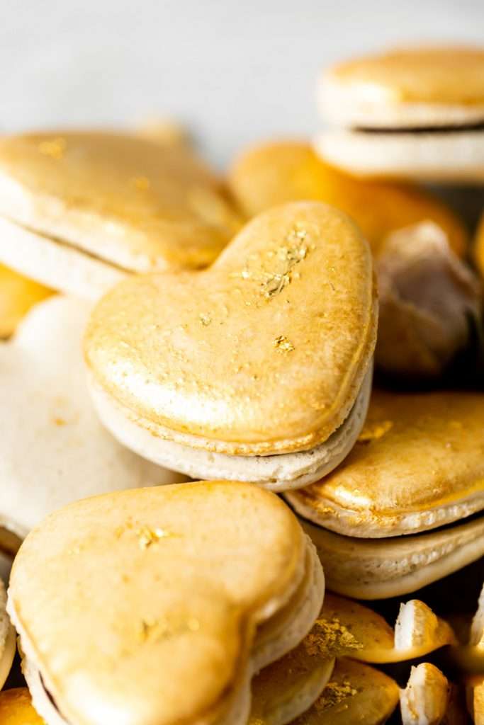 Heart macarons filled with hazelnut Nutella dark chocolate ganache, for Valentine's Day. Dairy and gluten free