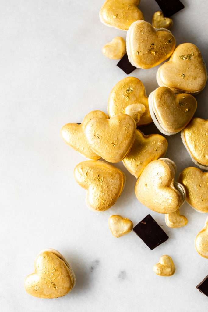 Heart macarons filled with hazelnut Nutella dark chocolate ganache, for Valentine's Day. Dairy and gluten free