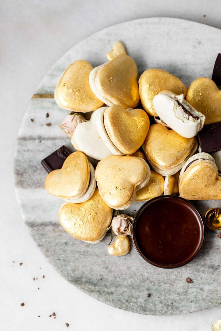 Heart macarons filled with hazelnut Nutella dark chocolate ganache, for Valentine's Day. Dairy and gluten free