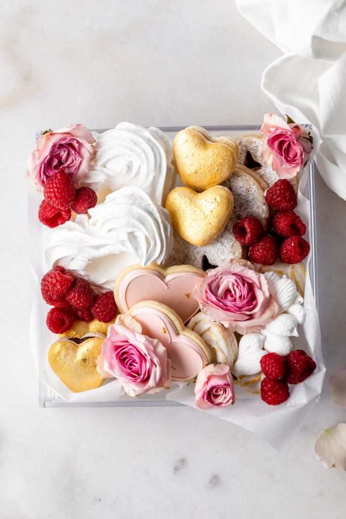 Inspiration for a pretty Valentine's Day box complete with macarons, sugar cookies, linzer cookies and pavlova