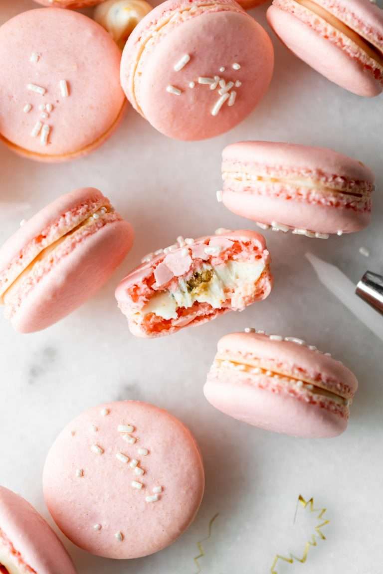 how to make birthday cake French macarons, filled with rainbow sprinkle frosting and rainbow cake crumbs. Dairy free & gluten free