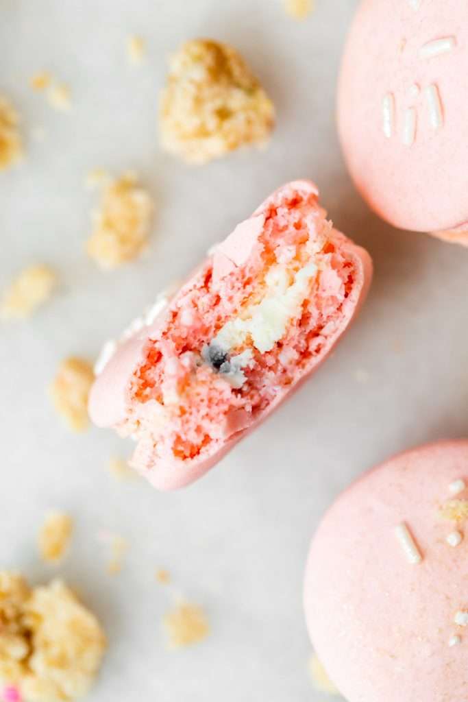 how to make birthday cake French macarons, filled with rainbow sprinkle frosting and rainbow cake crumbs. Dairy free & gluten free