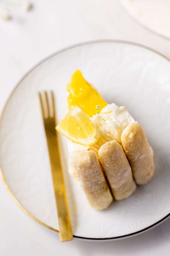 A bright and cheery lemon Charlotte cake, made with 4" macaron shells in place of sponge. Filled with lemon frosting and lemon curd. Dairy and gluten free.