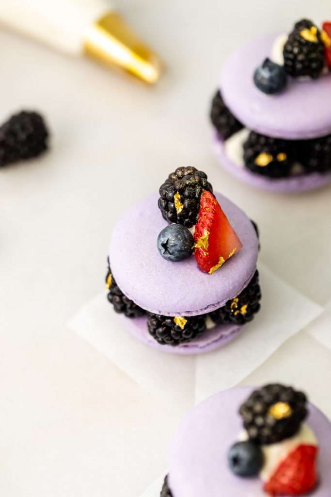 Laduree inspired summer French macarons filled with fresh blackberries and blueberries and lime filling. A dairy and gluten free variation perfect for seasonal gatherings and dessert menus.