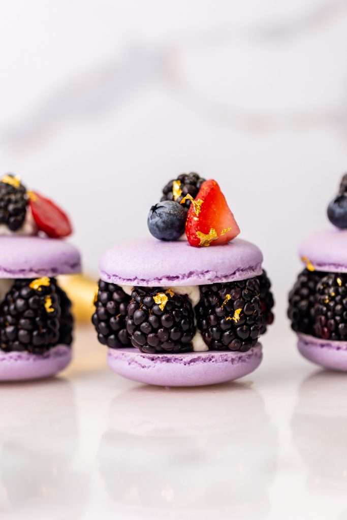 Laduree inspired summer French macarons filled with fresh blackberries and blueberries and lime filling. A dairy and gluten free variation perfect for seasonal gatherings and dessert menus.