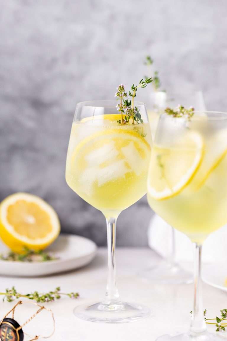 Bright and refreshing Limoncello Spritz cocktail, mixed with Prosecco and and garnished with thyme for freshness! A quintessential cocktail for summer entertaining.