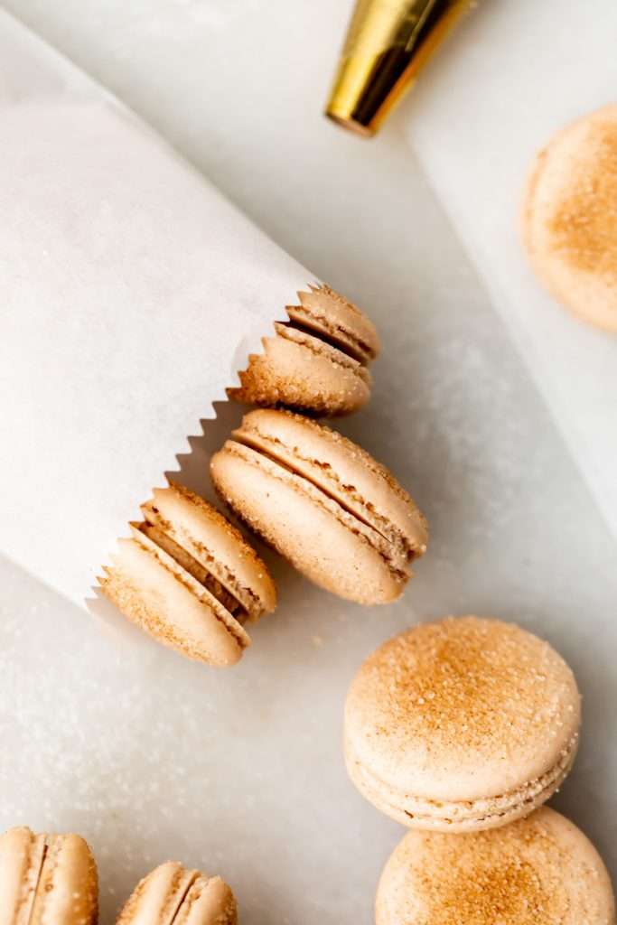 Churro flavored French macarons baked with cinnamon and sugar and filled with cinnamon flavored frosting. Dairy and gluten free