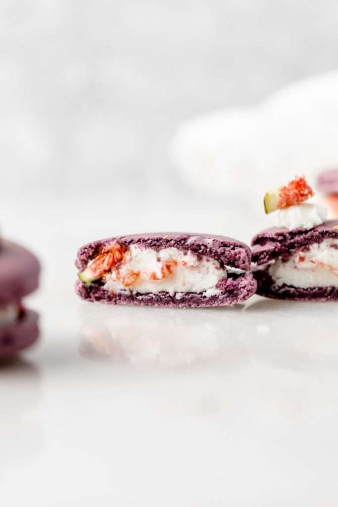 Fresh fig and vanilla bean French macarons. A delicious flavor combination for the fall season! Perfect for autumn celebrations and gatherings. Recipe and assembly video.